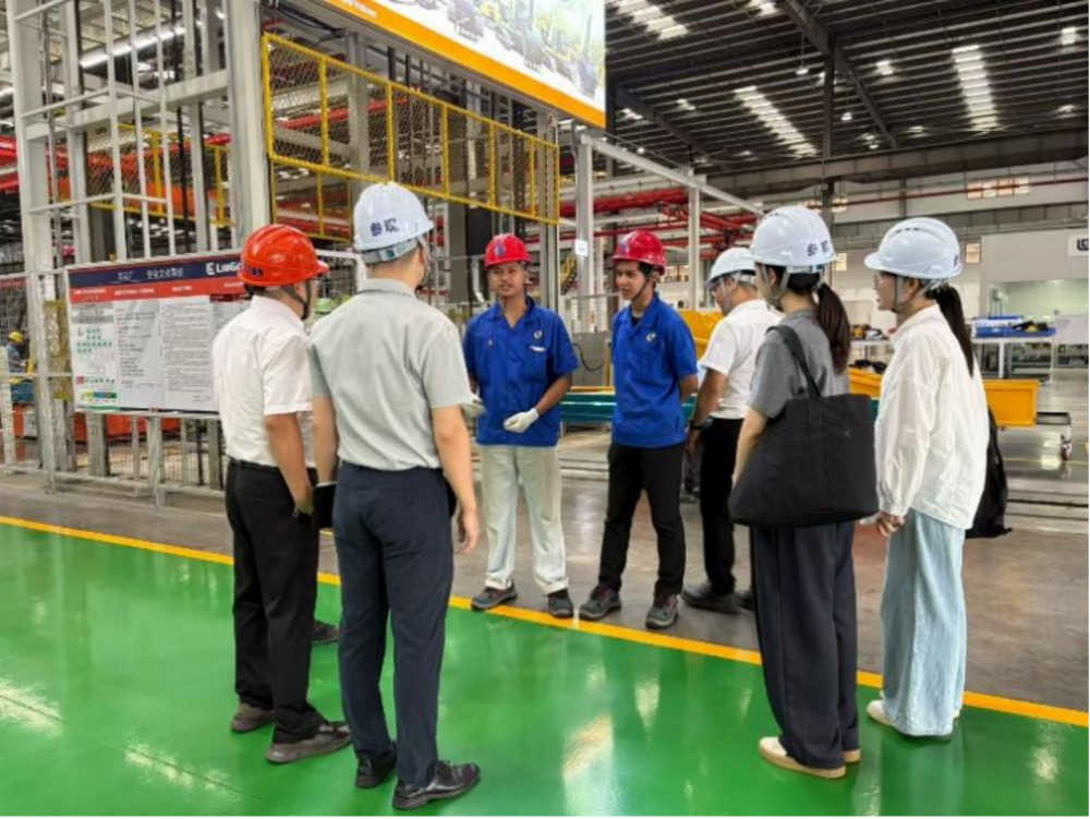 Teachers Learn About the Recent Internship and Life Situations with Indonesian Students Wang Haotian (3rd from Left) and Ryan (4th from Left) by the Assembly Workstation